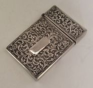 A heavy Indian silver card case chased with flower