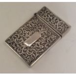 A heavy Indian silver card case chased with flower