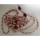 A long string of coral and pearl beads together wi