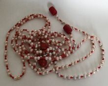 A long string of coral and pearl beads together wi