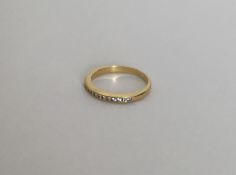 An 18 carat gold diamond half eternity ring. Appro