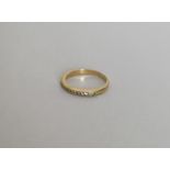 An 18 carat gold diamond half eternity ring. Appro