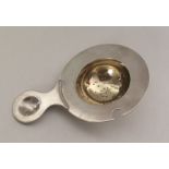 A Russian silver and silver gilt tea strainer. Pun