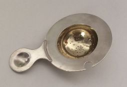 A Russian silver and silver gilt tea strainer. Pun
