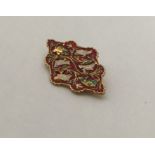 A high carat gold enamelled brooch decorated with