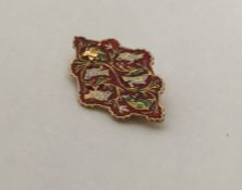 A high carat gold enamelled brooch decorated with