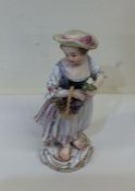 A decorative Meissen figure of a girl with basket.