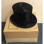 A top hat contained within a box. Approx. 20 cms x