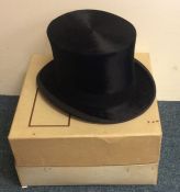 A top hat contained within a box. Approx. 20 cms x