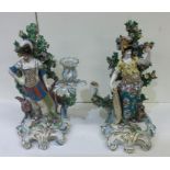 A pair of large decorative candle holders in brigh