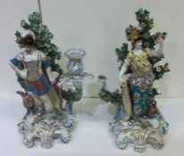 A pair of large decorative candle holders in brigh