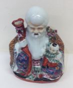 A Chinese figure of a sage and boy decorated in br