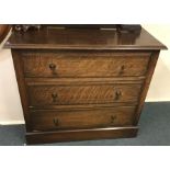 An oak three drawer chest. Est. £15 - £20.
