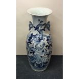 A tall Chinese blue and white vase decorated with