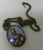 A small Italian religious miniature on gilt chain.