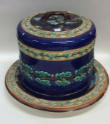 A large majolica cheese dome decorated with acorns