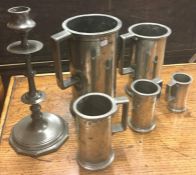 A good set of pewter tankards of tapering form. Es