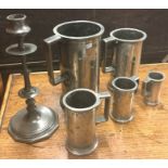 A good set of pewter tankards of tapering form. Es