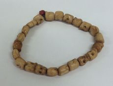 An unusual bracelet in the form of skulls. Est. £2