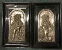 A pair of ebony framed plated wall plaques depicti