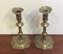 A pair of 18th Century brass candlesticks with sha