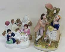 A tall Staffordshire figure of a romantic couple t