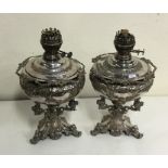 An unusual pair of good silver plated oil lamps wi