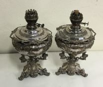 An unusual pair of good silver plated oil lamps wi