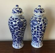 A pair of Chinese blue and white floral vases. Est