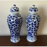 A pair of Chinese blue and white floral vases. Est