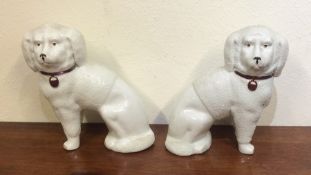 A pair of Staffordshire dogs with frosted decorati