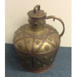 A massive brass ewer with lift-off cover and coppe