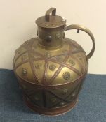 A massive brass ewer with lift-off cover and coppe