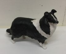 A Beswick figure of a Collie dog with bushy coat.