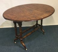 A Victorian burr walnut Sutherland table on turned