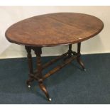 A Victorian burr walnut Sutherland table on turned