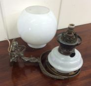 An unusual wall mountable brass oil lamp decorated