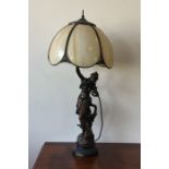 A tall spelter lamp in the form of a lady with flo