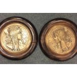 A pair of Art Nouveau circular brass plaques in oa