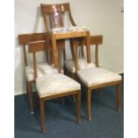 A set of four maple chairs on spreading supports t