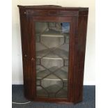 A large Georgian mahogany glazed corner cupboard w