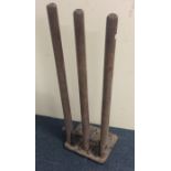 A set of training cricket stumps on cast iron base