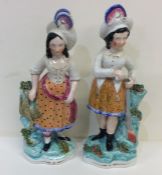 A pair of Staffordshire figures decorated in brigh