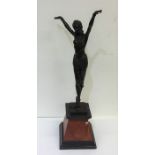 A tall spelter figure of a dancing lady on taperin