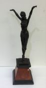 A tall spelter figure of a dancing lady on taperin