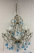 A stylish blue glass chandelier with matching drop