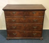 A good Georgian chest of five drawers on bun feet