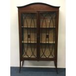 A Victorian inlaid two door cabinet with swag deco