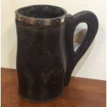 An unusual leather and silver mounted jug of shape