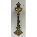 A tall brass oil lamp on step base with bead work